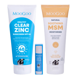 Three MooGoo skincare products arranged on a white background: a large blue tube of Healthy Clear Zinc sunscreen SPF 40, a smaller blue tube of Natural SPF 15 Lip Balm, and a large white-and-gold tube of Natural Soothing MSM Moisturiser. MooGoo Summer essentials pack for after sun care. 