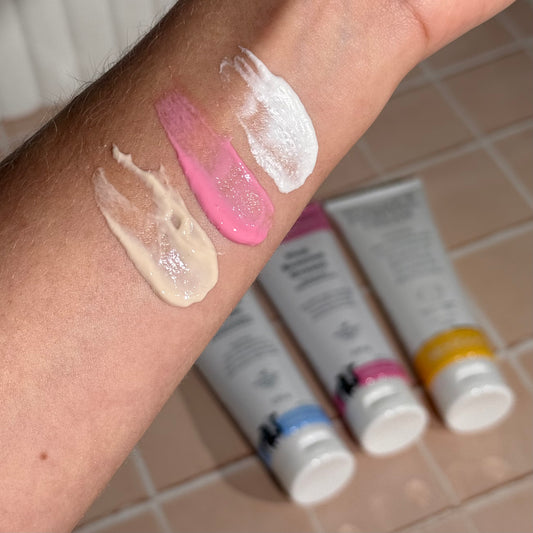 MooGoo Eczema and Psoriasis Cream Marshmallow Elderberry, Eczema and Psoriasis Cream Gotu Kola Chamomile, and Pink Eczema Cream Vitamin B12 swatches on wrist, soothing cream for sensitive eczema and psoriasis prone skin.