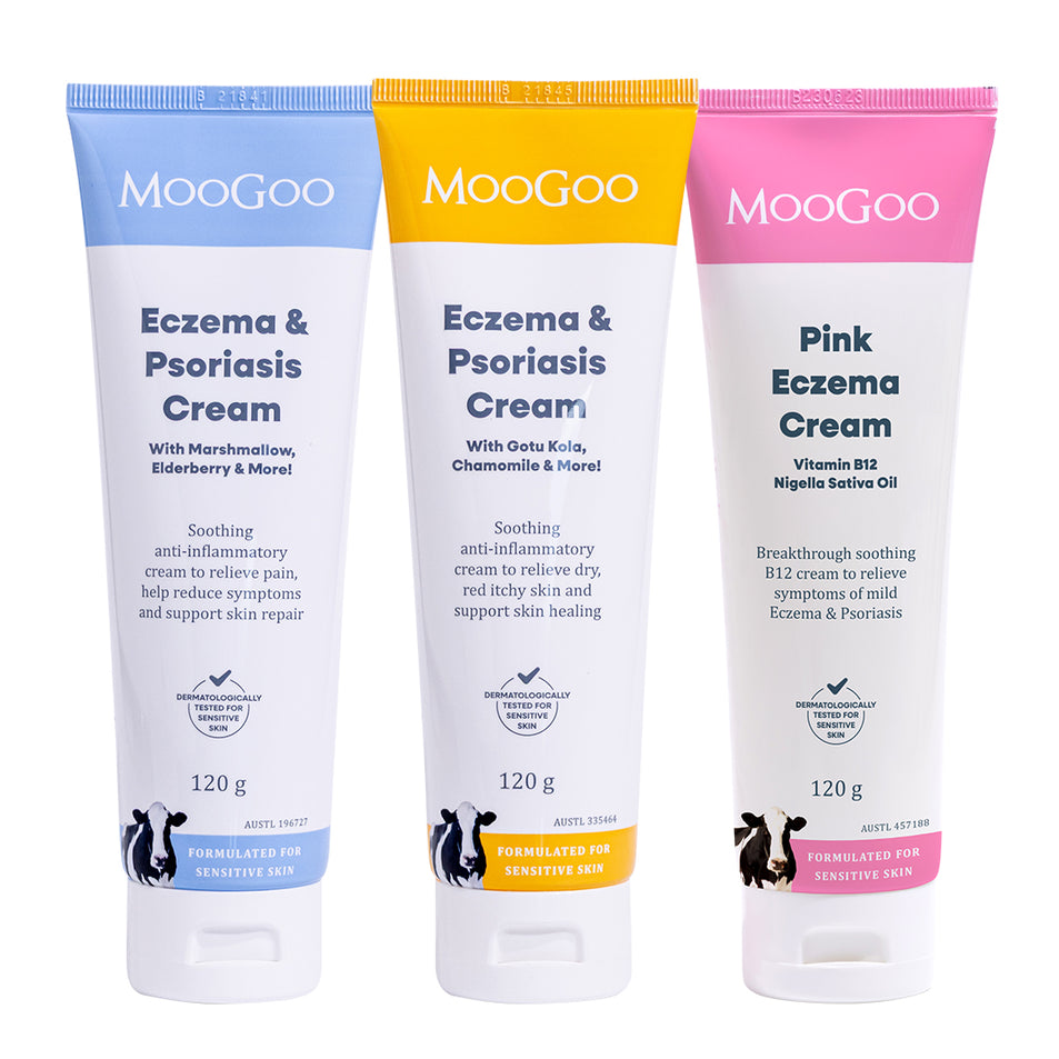 Three MooGoo Eczema & Psoriasis Cream tubes in blue, yellow, and pink packaging, displayed side-by-side on a white background. MooGoo Eczema and Psoriasis Cream Marshmallow Elderberry, Eczema and Psoriasis Cream Gotu Kola Chamomile, and Pink Eczema Cream Vitamin B12, soothing cream for sensitive eczema and psoriasis prone skin. 