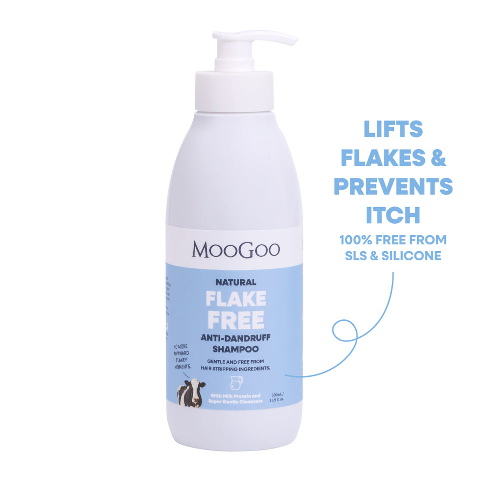 MooGoo Natural Flake Free Anti-Dandruff Shampoo in a white pump bottle with a blue label, shown on a white background with promotional text on the right. Gentle SLS-free cleanser to fight dandruff and soothe itchy, flaky scalp