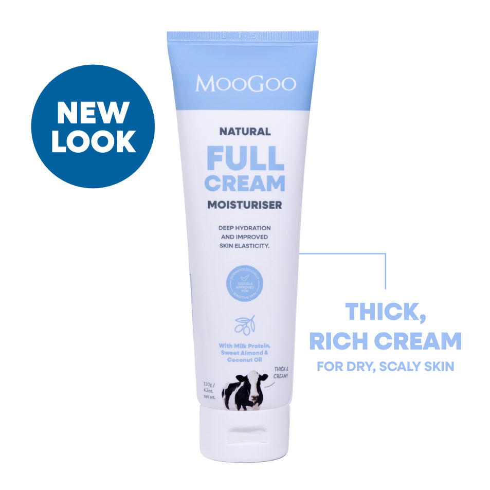 MooGoo Natural Full Cream Moisturiser in a white squeeze tube with light blue accents, shown on a white background with a blue 'NEW LOOK' badge and descriptive text. Everyday face and body cream to boost elasticity and hydrate sensitive skin.