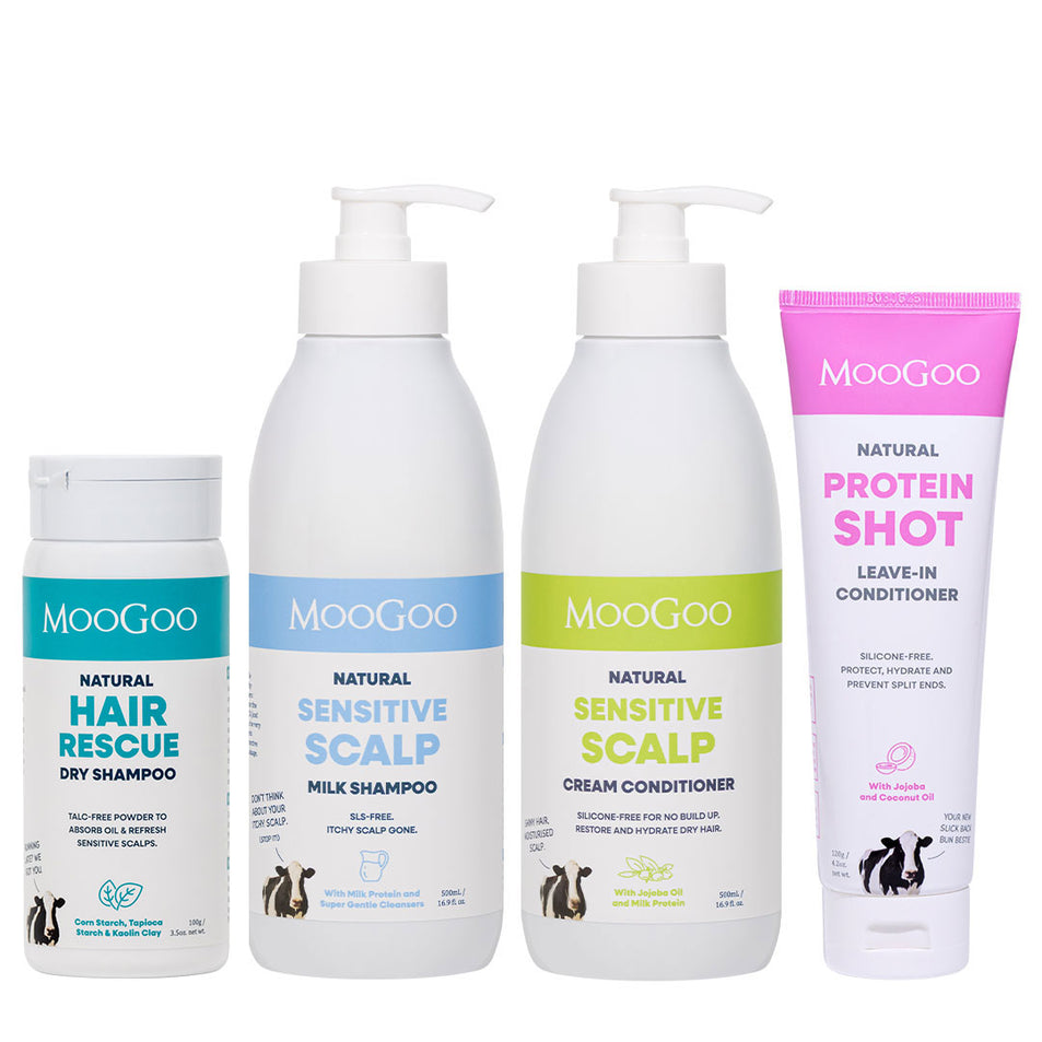 Four MooGoo haircare products arranged on a white background: a small Hair Rescue Dry Shampoo bottle, a Sensitive Scalp Milk Shampoo pump bottle, a Sensitive Scalp Cream Conditioner pump bottle, and a Protein Shot Leave-In Conditioner squeeze tube. 