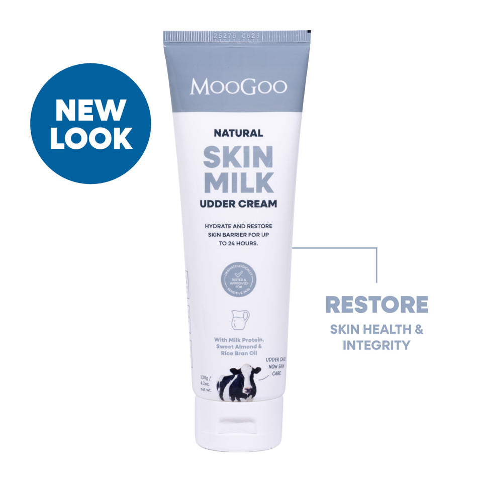 MooGoo Natural Skin Milk Udder Cream tube on a white background with a blue 'NEW LOOK' badge and supporting text. Natural restorative moisturiser with aloe vera and vitamin E for dry, sensitive or damaged skin.