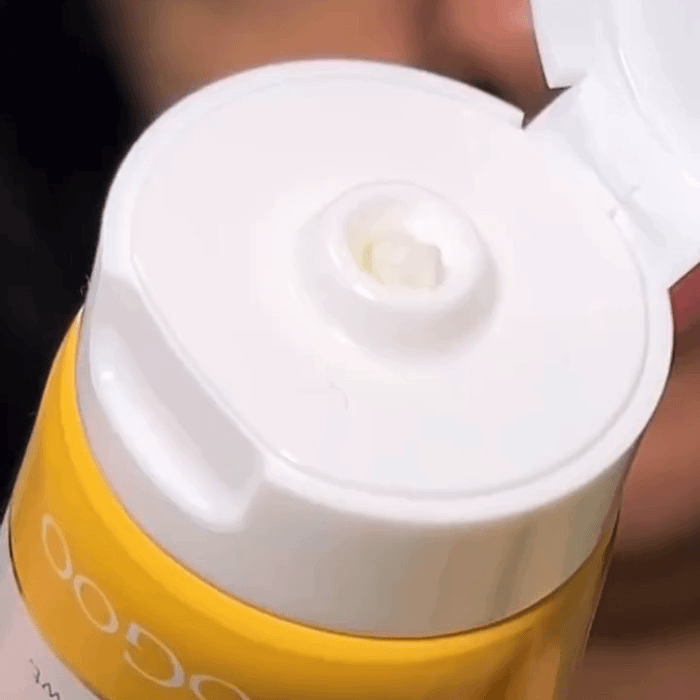 Woman applying the MooGoo Eczema & Psoriasis Cream to her face.