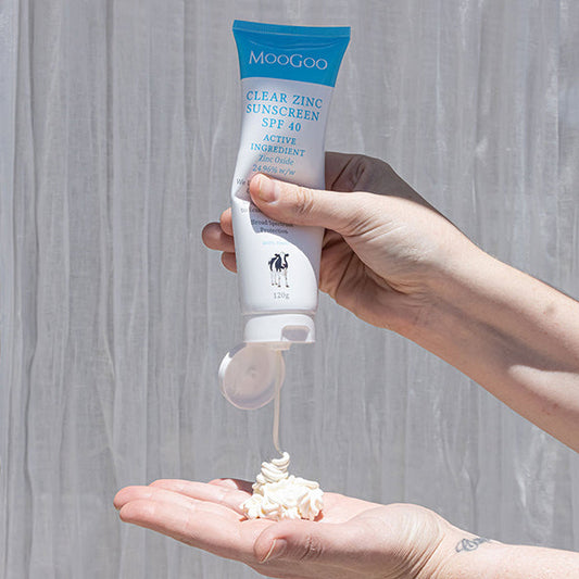 MooGoo Clear Zinc Sunscreen SPF 40 being applied onto hand, natural zinc oxide sunscreen for sensitive skin with broad spectrum UVA UVB protection